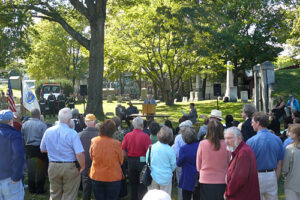 Historian Robert Romer addresses a gathering at West Cemetery to honor the Afircan American Civil War Veterans of Amherst